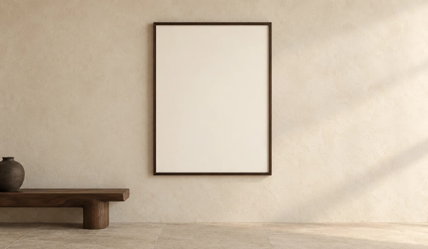 A large walnut-framed artwork on a warm plaster wall beside a sculptural walnut bench